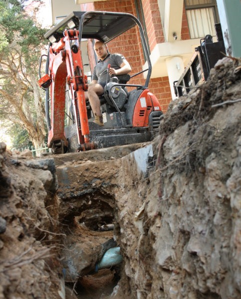 Digging drain with excavator