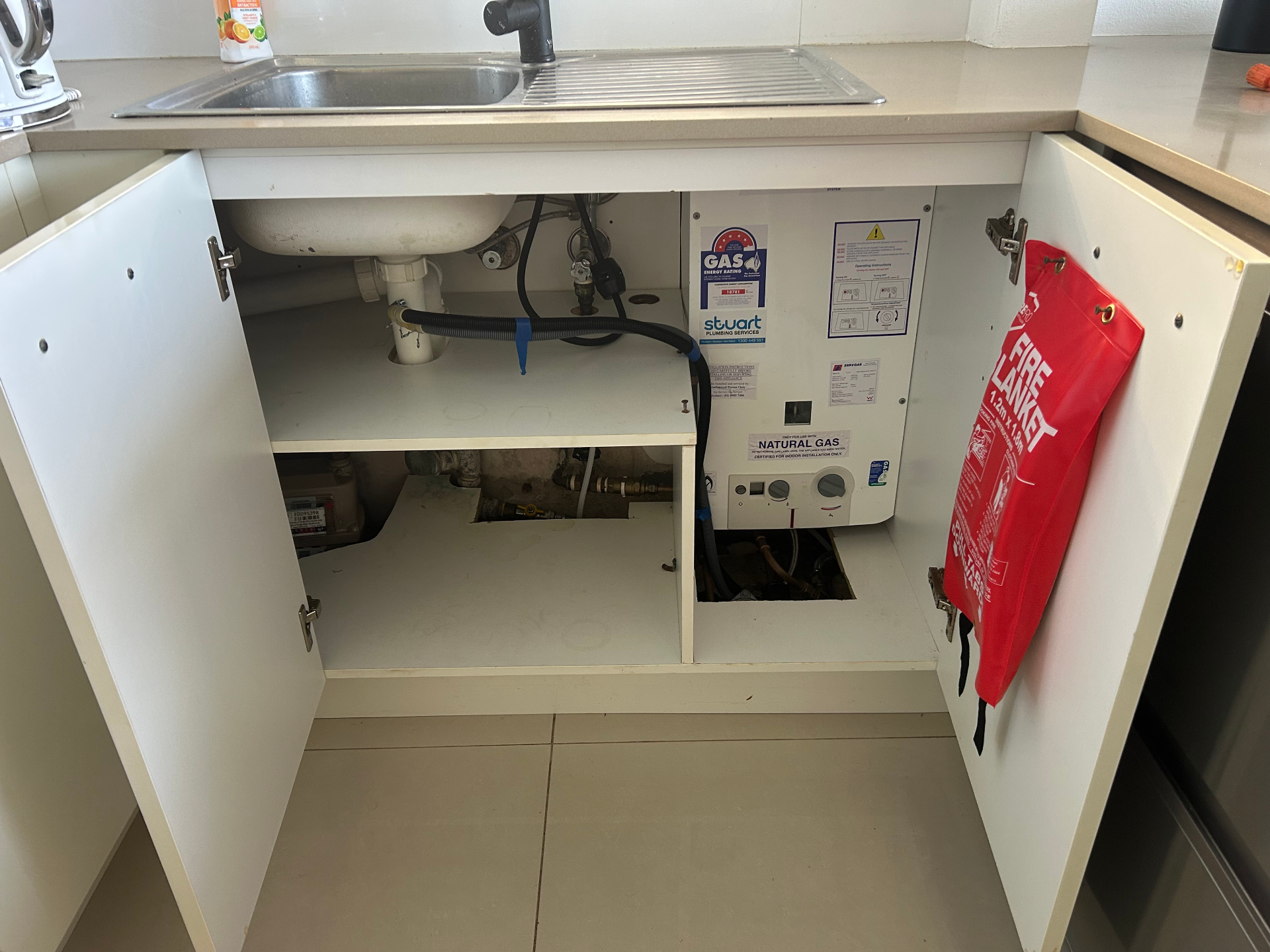 kitchen sink with open cupboard