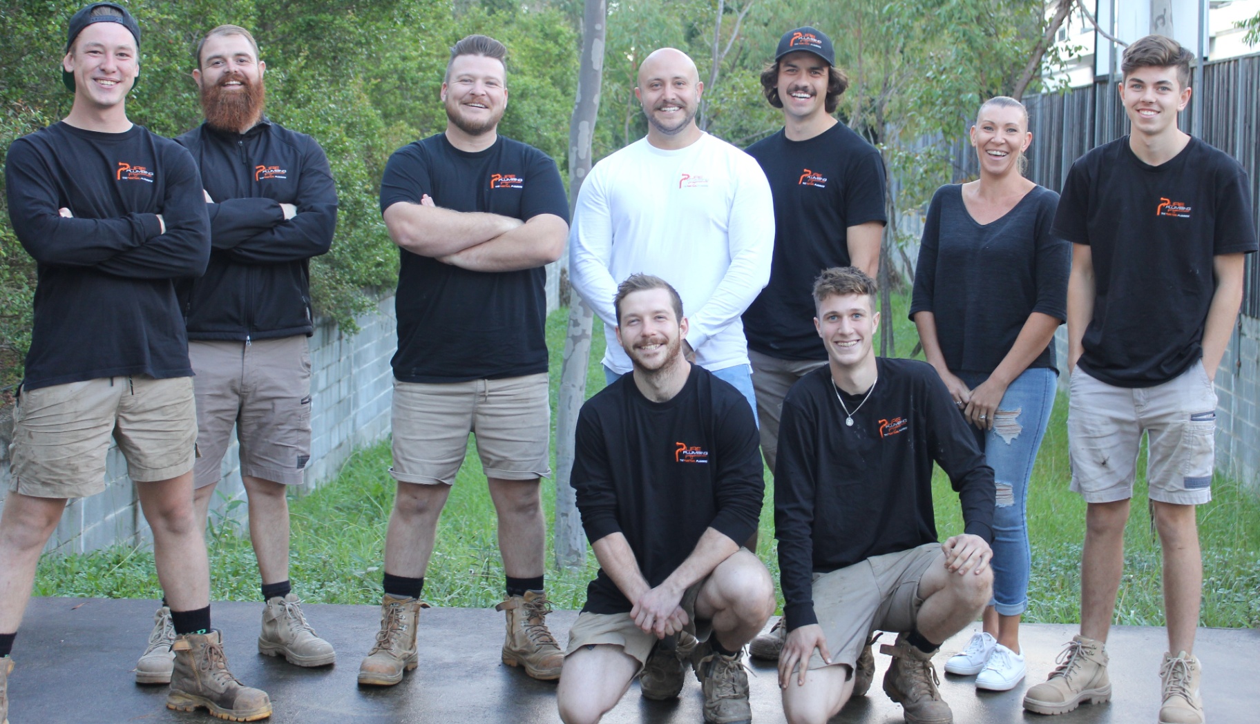 Pure Plumbing team with all smiling staff wearing branded tshirts