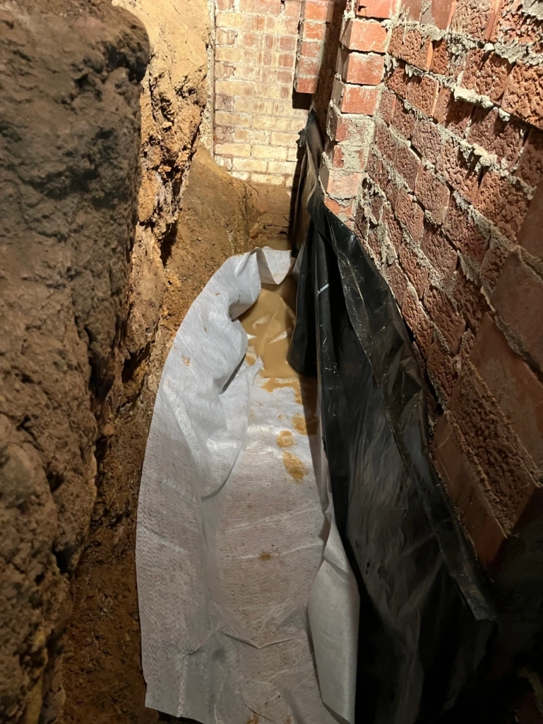 Plastic water proofing applied to wall
