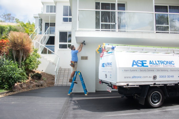 Electrician installing security lighting