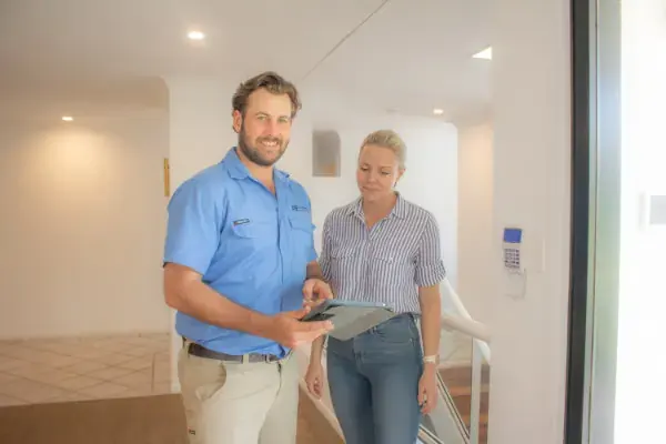 Alltronic expert security specialist holding a tablet explaining the customised security alarm and security camera system that will be installed indoors and outdoors to make her home secure