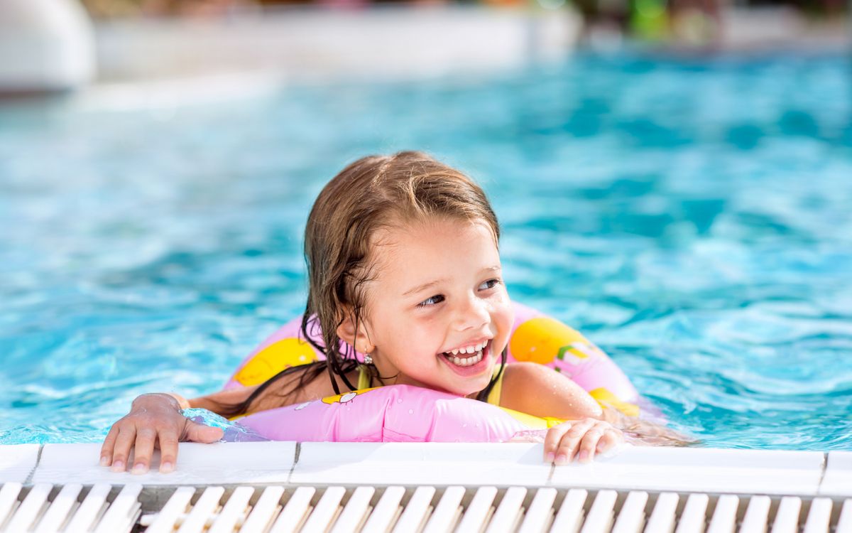Child in pool with float