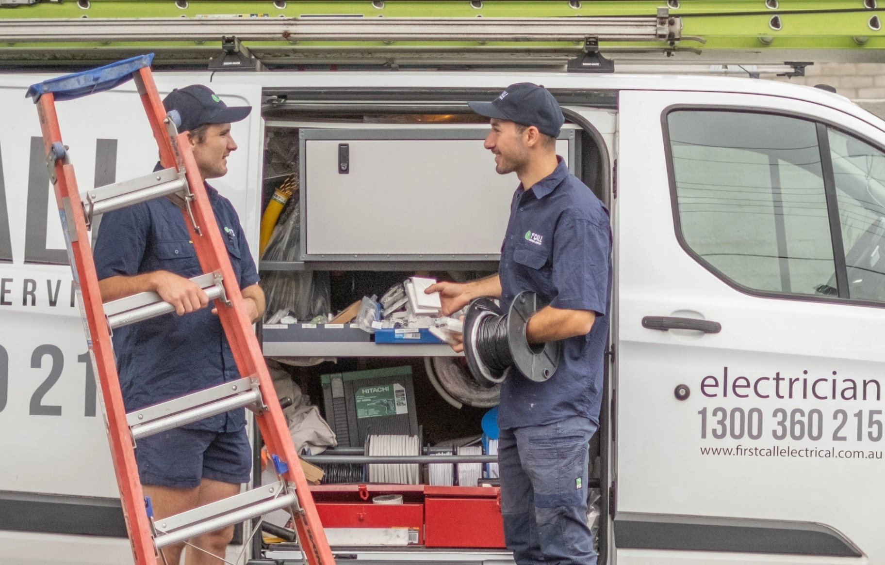 First Call Security technicians with ladder, cabling and security cameras to install around a residential property