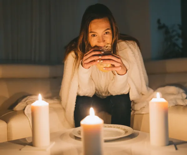 lady eating by candle light