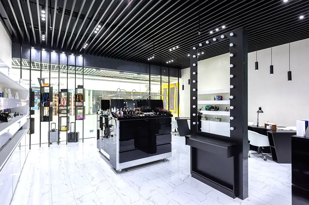 Commercial retail space of an shopping centre fitted out for cosmetics and hair services with illuminating commercial lighting installation