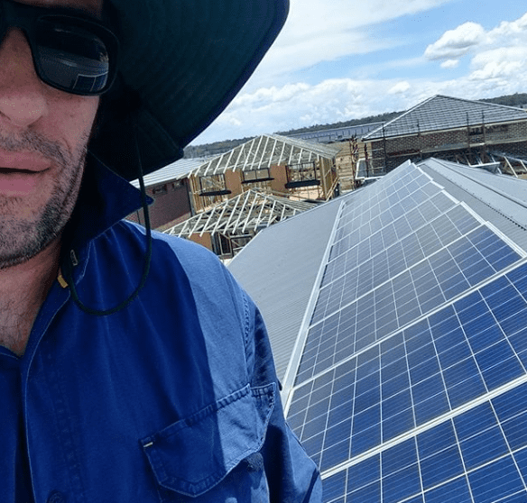 Powerix technician on roof with solar panels