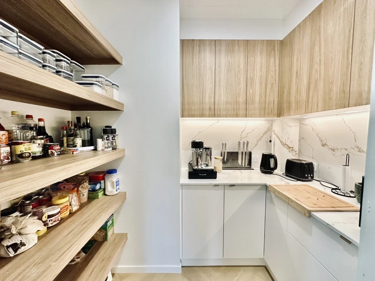 kitchen and laundry custom cabinetry on soft oak coloured wood cabinet doors with matching wooden shelves for extra kitchen storage