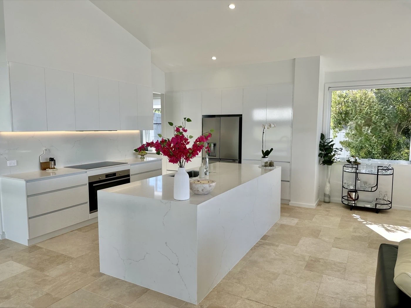 The finished kitchen installed with a stone waterfall island