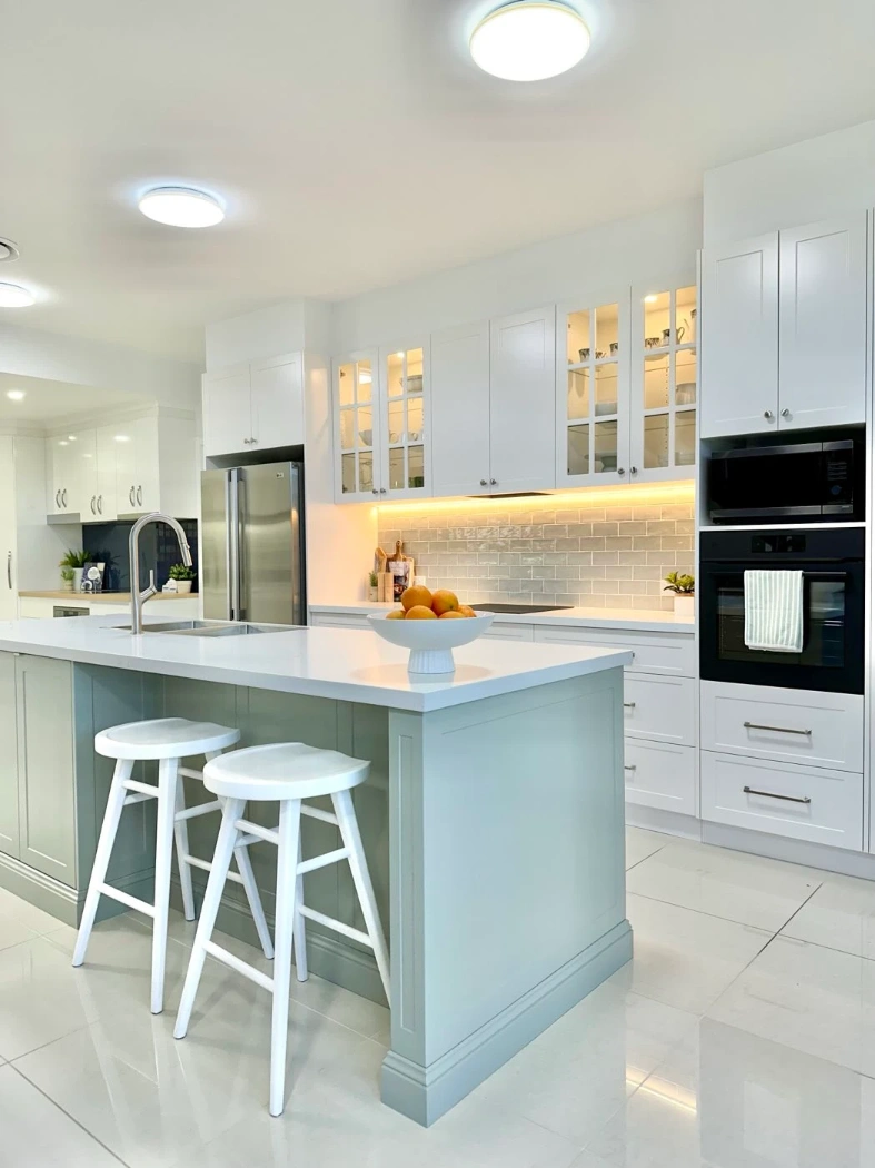 Display kitchen island with stone benchtop, breakfast bar and subway tile splashback