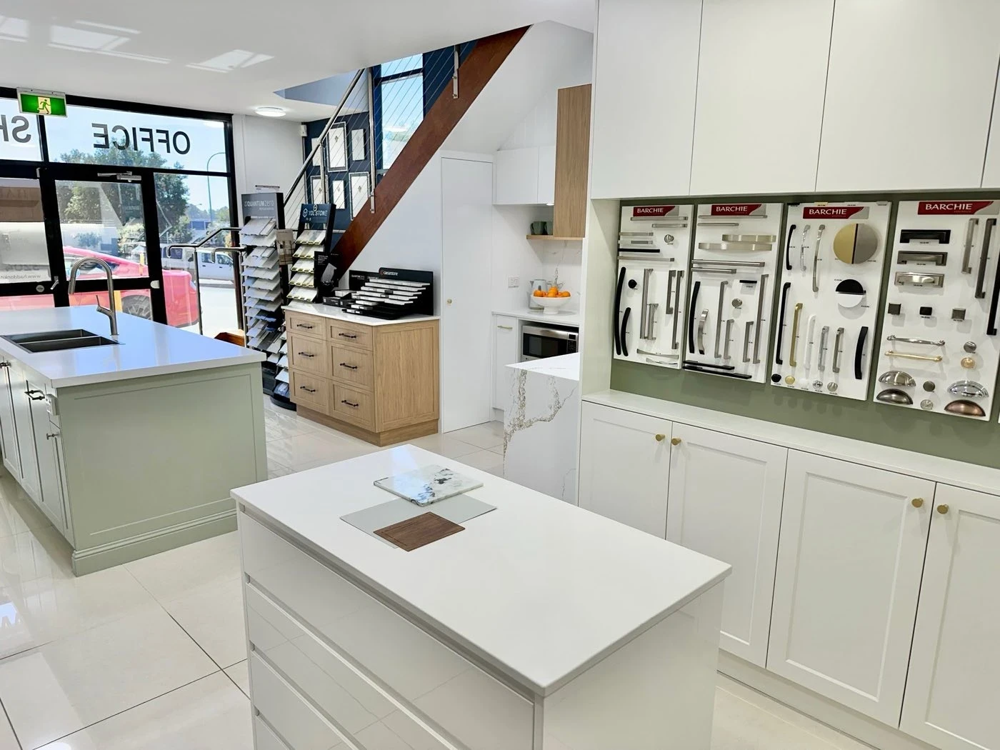 Showroom floor with two display islands and the cabinet hardware wall
