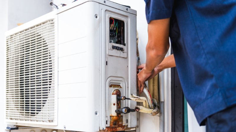 Air conditioning technician performing full service of the external unit including doing a full regas and any repairs that are required. Rust and corrosion present on the outdoor aircon unit