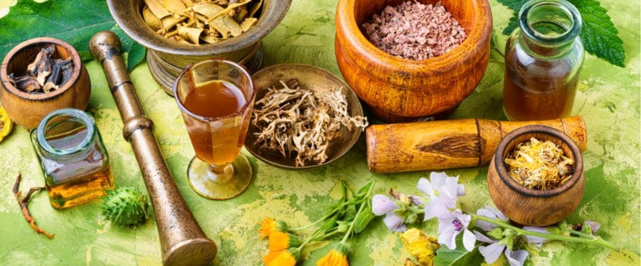 pestle and mortar with a variety of herbs