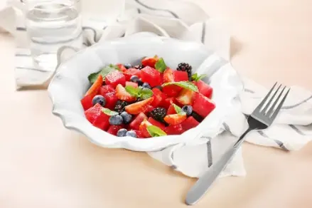 Bowl of fresh fruit and glass of water