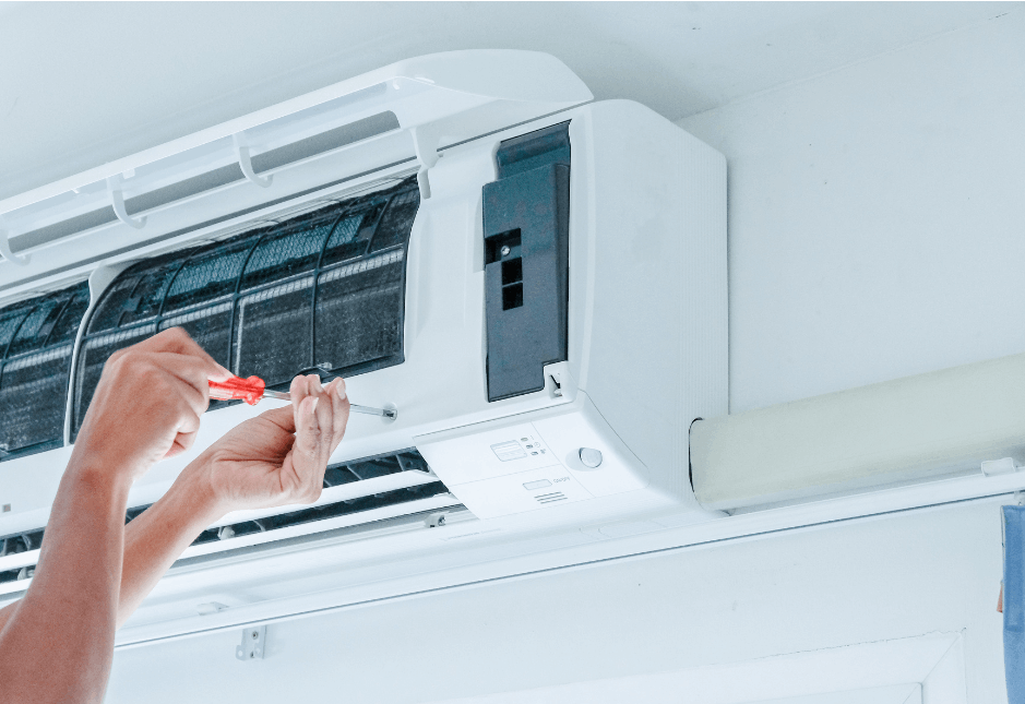 technician repairing indoor AC unit