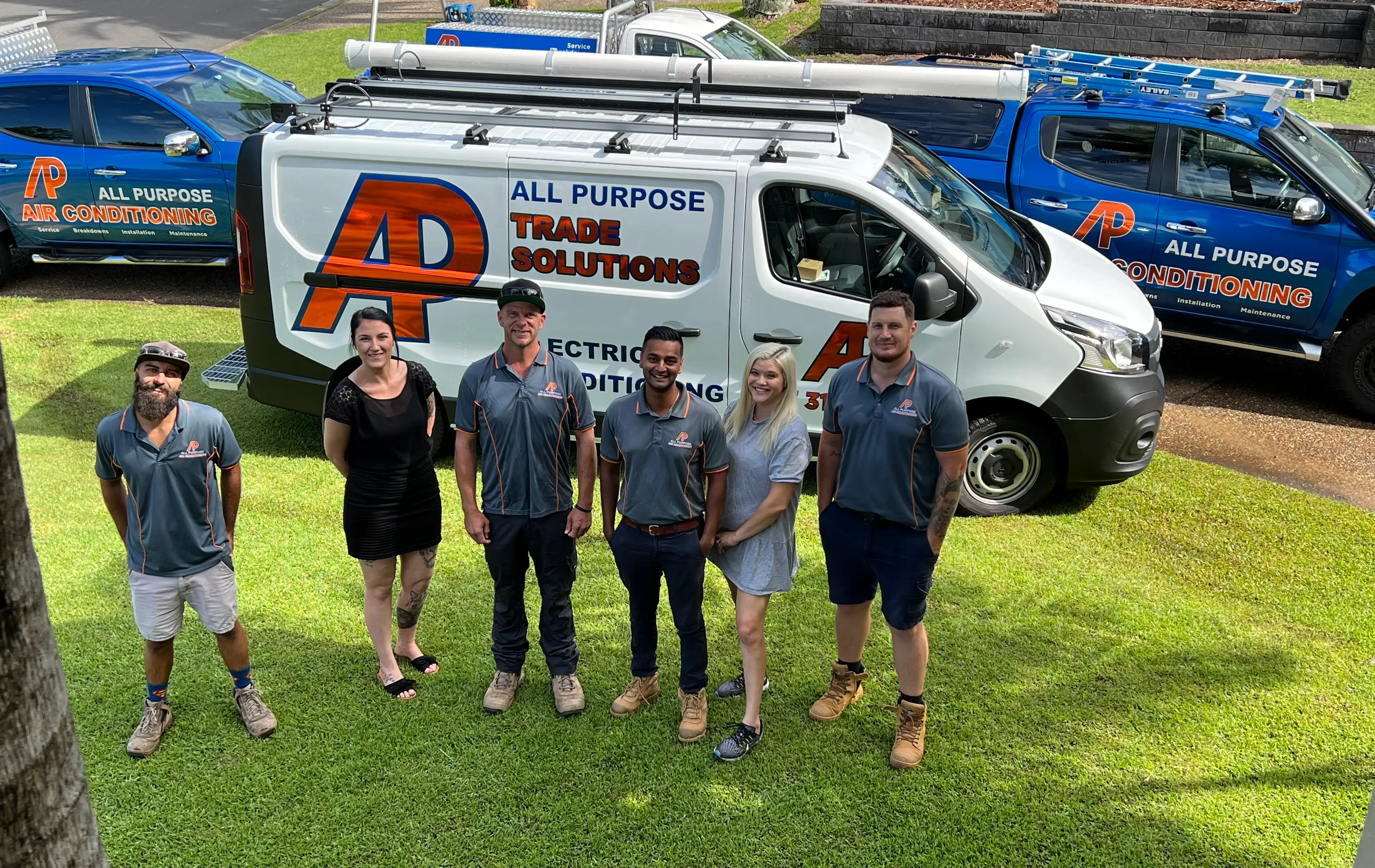 All Purpose HVAC specialist team all stood in front of branded utes