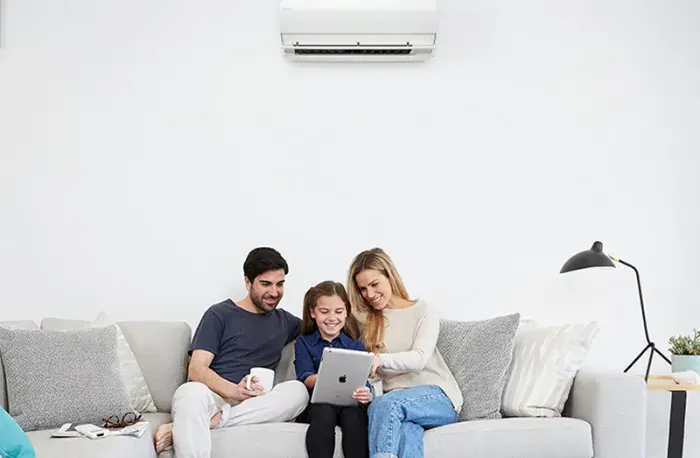 family relaxing in air conditioned room