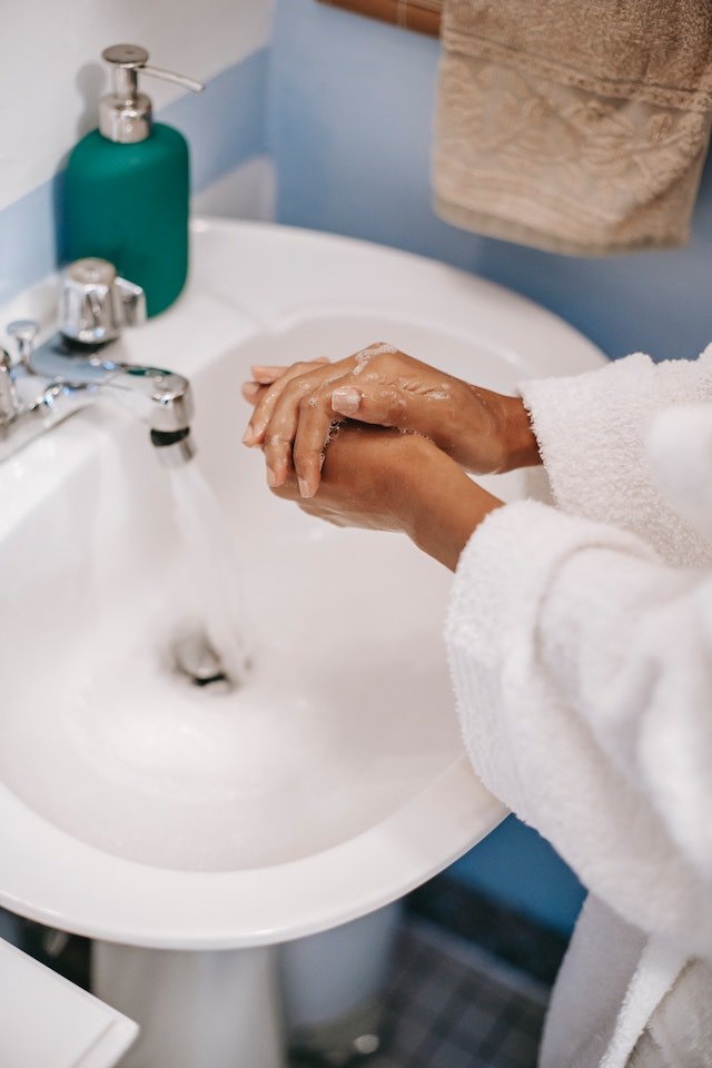 washing hands with liquid hand soap