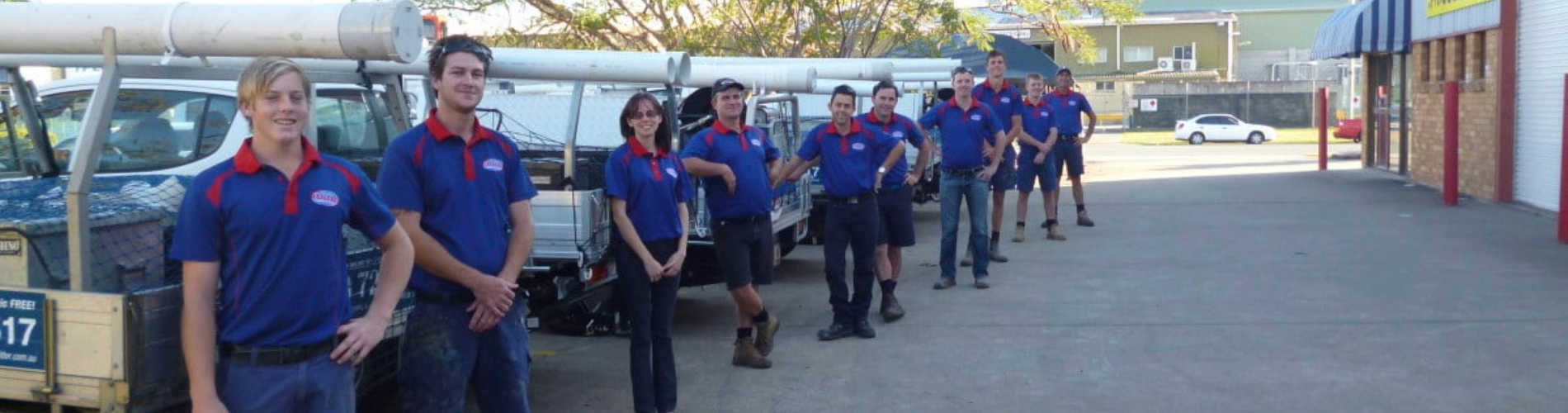 The Express Wastewater Solutions team stood smiling in branded uniform and with branded utes. Ready to help you with all your wastewater queries and needs