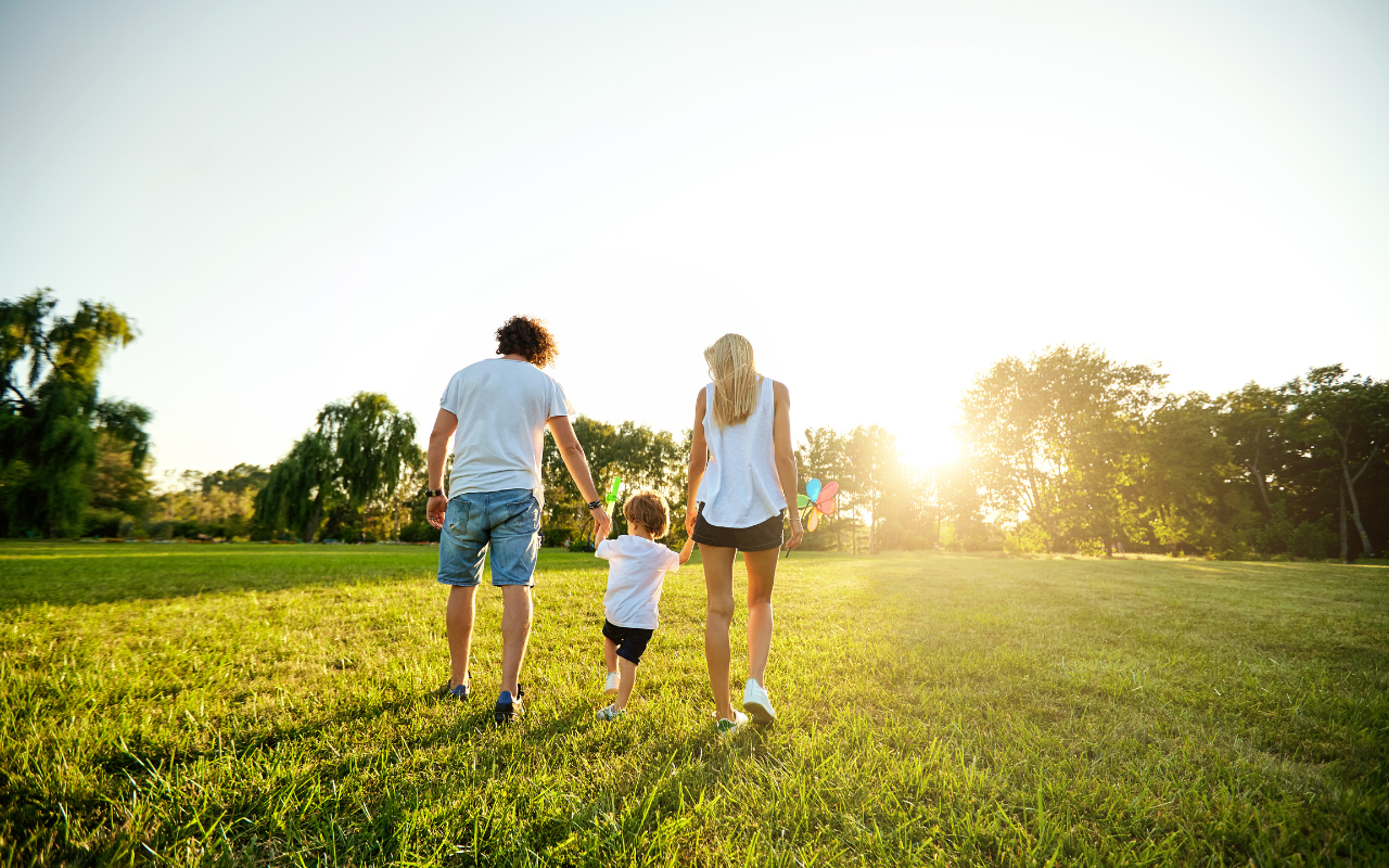 family walking a green grass