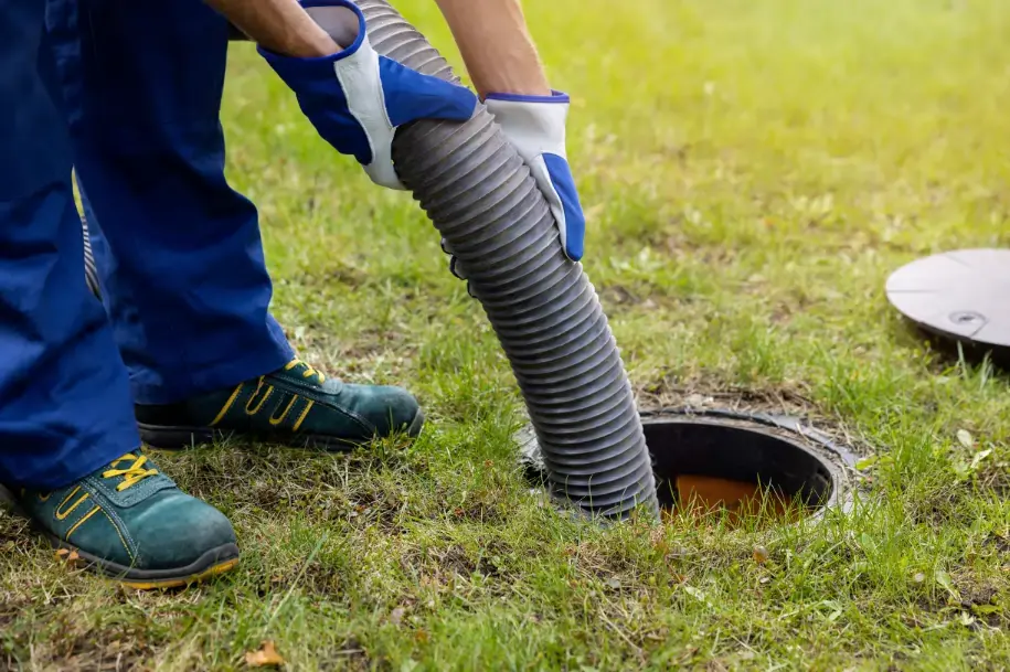 technician  pumping out septic tank 