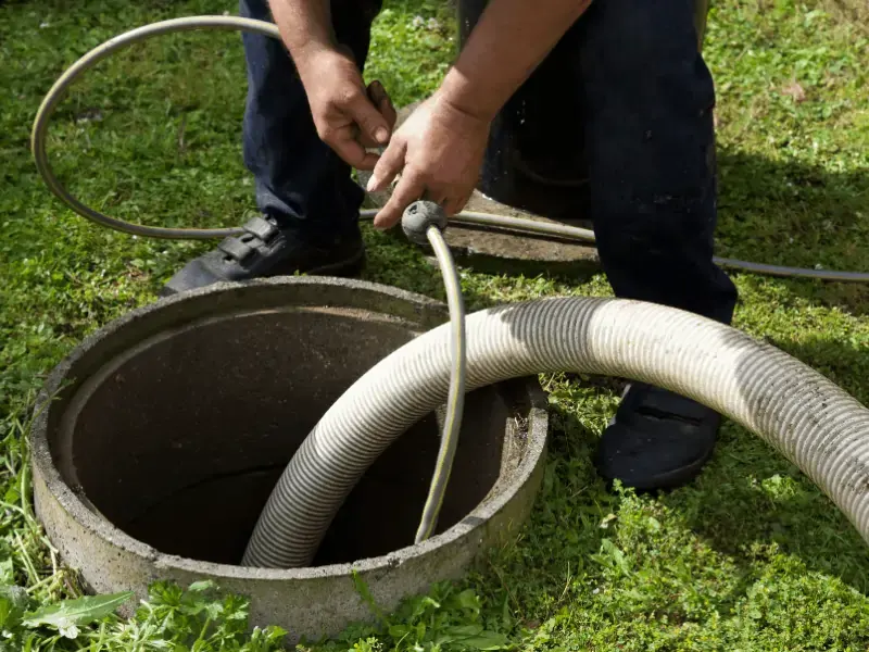 technician performing septic tank pump out