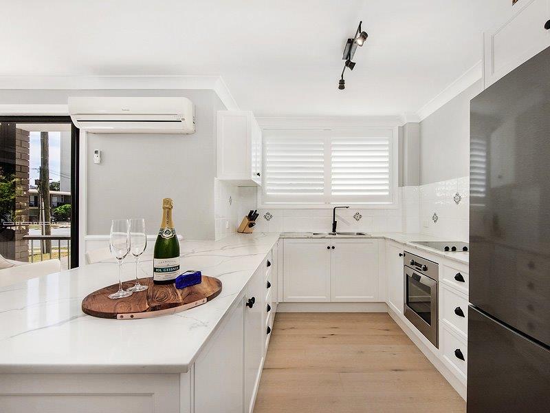 large white kitchen with high gloss benchtops