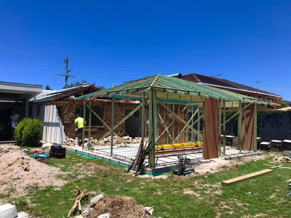 New Home Builders: Expert design & Build professionals stood in the frame of a new house being built from designs