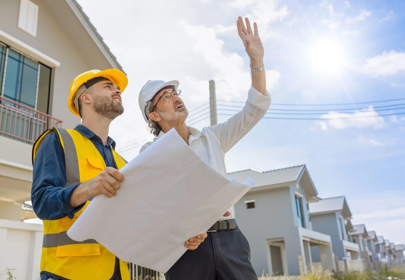 A builder going through every aspect of the build Contract with a client to make sure they Understand the Stages of the build and exactly what they’re signing before putting pen to paper.