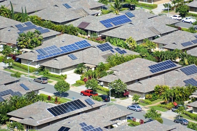 Houses with rooftop solar panels with trees around