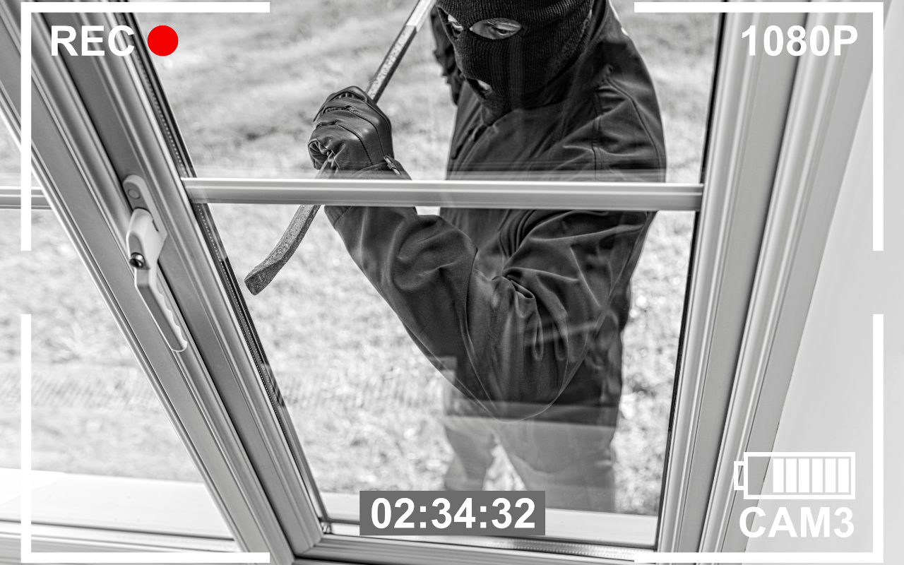 Security Camera recording a person breaking into window