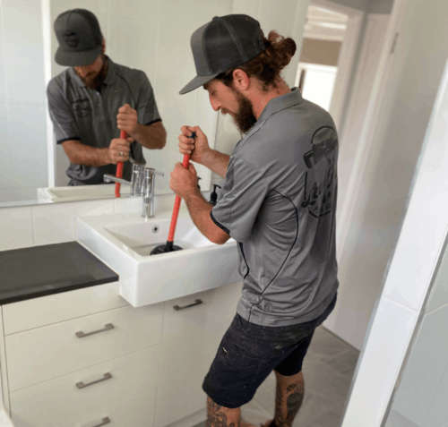 plumber cleaning drain