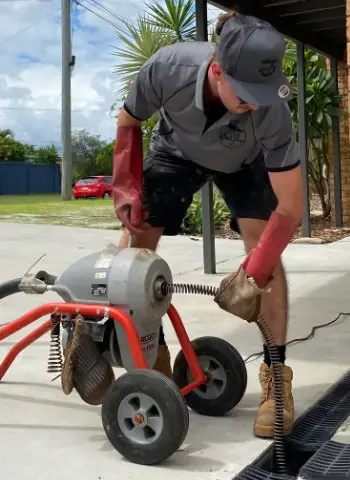 technician cleaning blocked drains