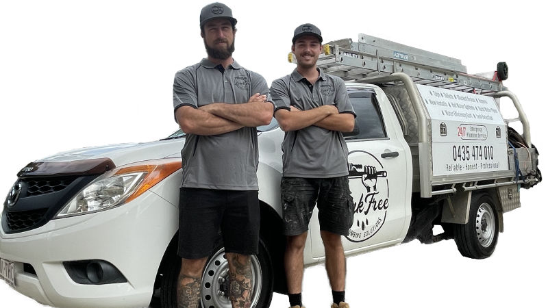 Plumbers standing next to work van