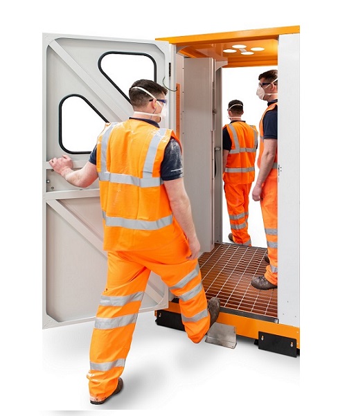 JetBlack Safety Personnel Cleaning Booth (walk-through, hands free) - man walking in, man in front of hands free air nozzles, man leaving booth, all in PPE gear