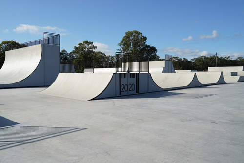 Dynamic action shot of a skateboarder performing tricks at Beenleigh Skate Park, one of Australia's oldest and most iconic skate parks, located in Logan, Queensland. A vibrant hub for skate enthusiasts and athletes.