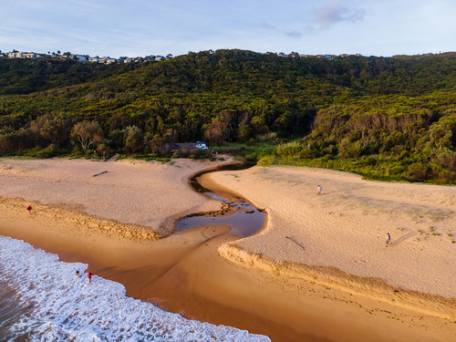 A breathtaking scene from Bouddi National Park, capturing its rugged coastal cliffs and lush greenery, a perfect backdrop for the park's renowned walking trails and rich Aboriginal heritage. 