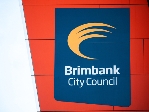 Close-up view of the Brimbank Council logo displayed prominently on the exterior of the council building. The logo is set against the modern architectural backdrop of the council's headquarters, symbolizing the council’s commitment to transparency and community-focused governance. 