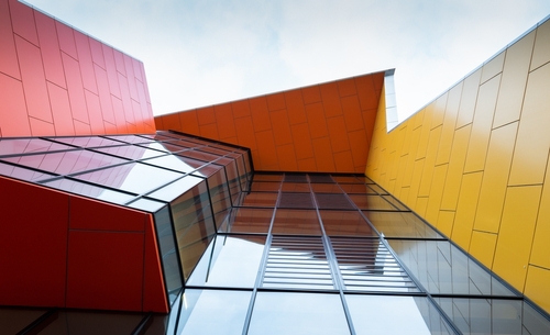 Exterior view of Brimbank Library featuring its modern facade and welcoming entrance, set against the backdrop of a well-landscaped public area. The image highlights the library's role as a community hub in Melbourne’s Brimbank area, showcasing its accessibility and the inviting nature that draws residents from diverse backgrounds. The design of the building reflects a commitment to community service and educational enrichment.