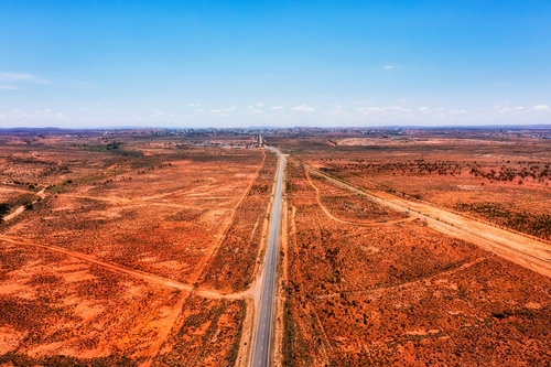 A striking view of Broken Hill, showcasing its heritage-listed architecture and mining structures, set against a backdrop of the vibrant arts scene, epitomizing its unique blend of history and culture.