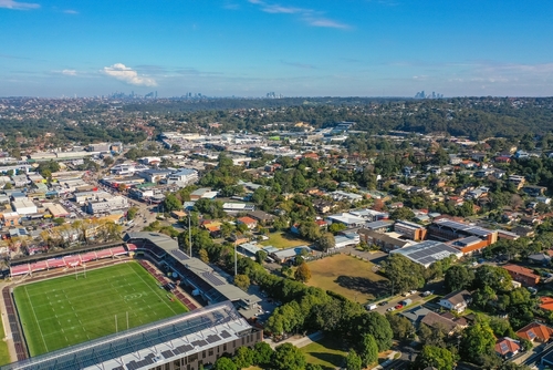 An exhilarating scene at Brookvale Oval during a Sea Eagles match, with the stands filled to capacity and fans decked out in team colours. The intensity of the game and the passionate support from the community encapsulate the spirit of Northern Beaches' sporting life.