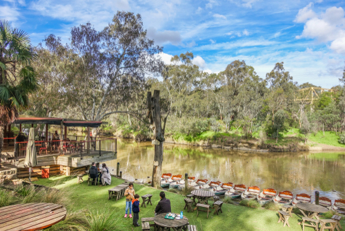 The iconic Fairfield Boathouse along the Yarra River in Darebin, Melbourne. This image showcases the Victorian-era boathouse and its reflection on the calm waters, framed by lush trees, creating a picturesque and peaceful setting ideal for leisure and rowing activities.