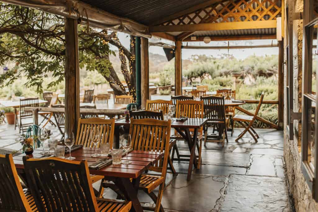  A rustic cellar door with tables set for wine tasting and gourmet dining. 