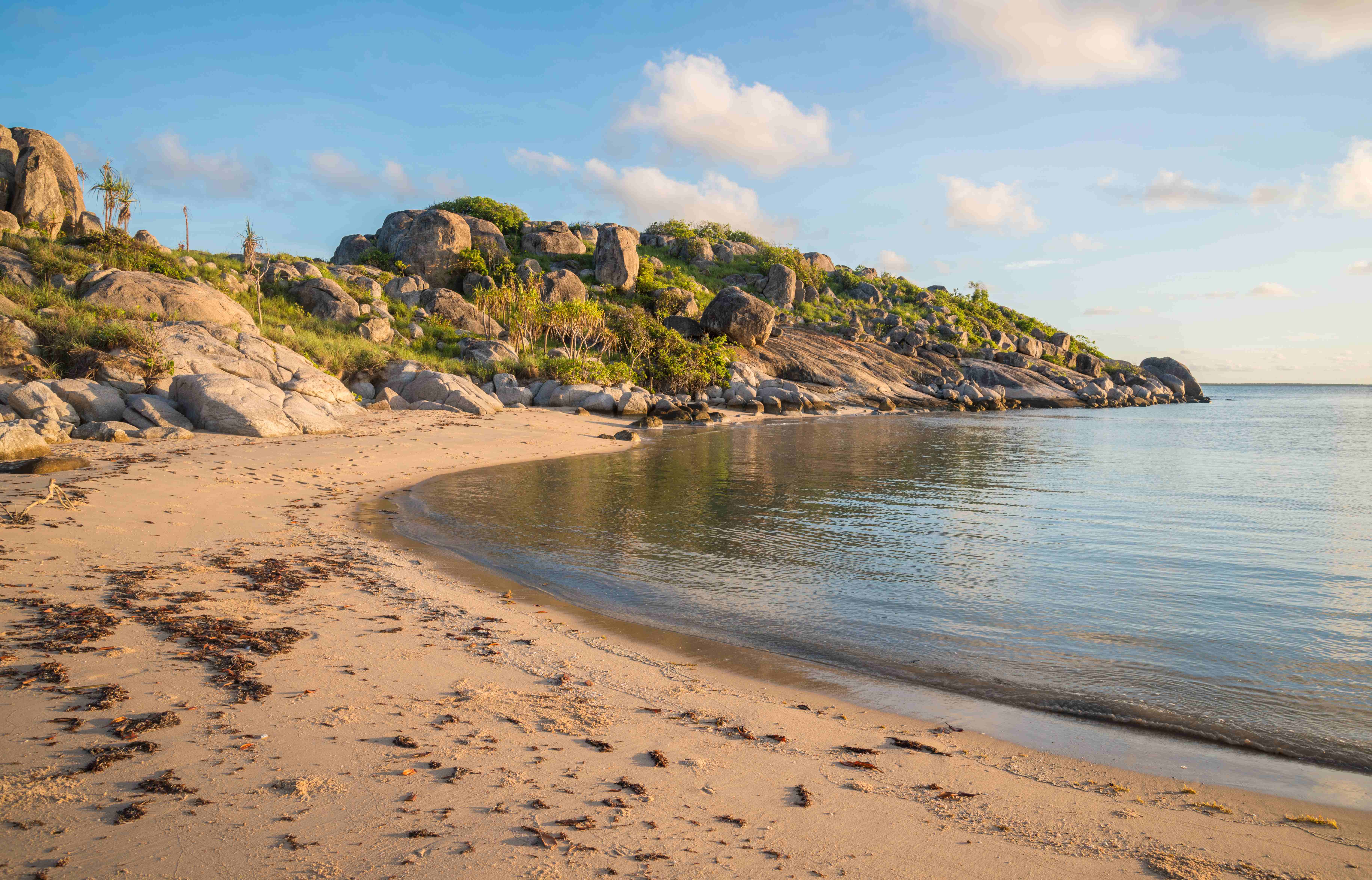 A panoramic view of the rugged coastline of the Gove Peninsula, with rocky cliffs, sandy beaches, and turquoise waters.    