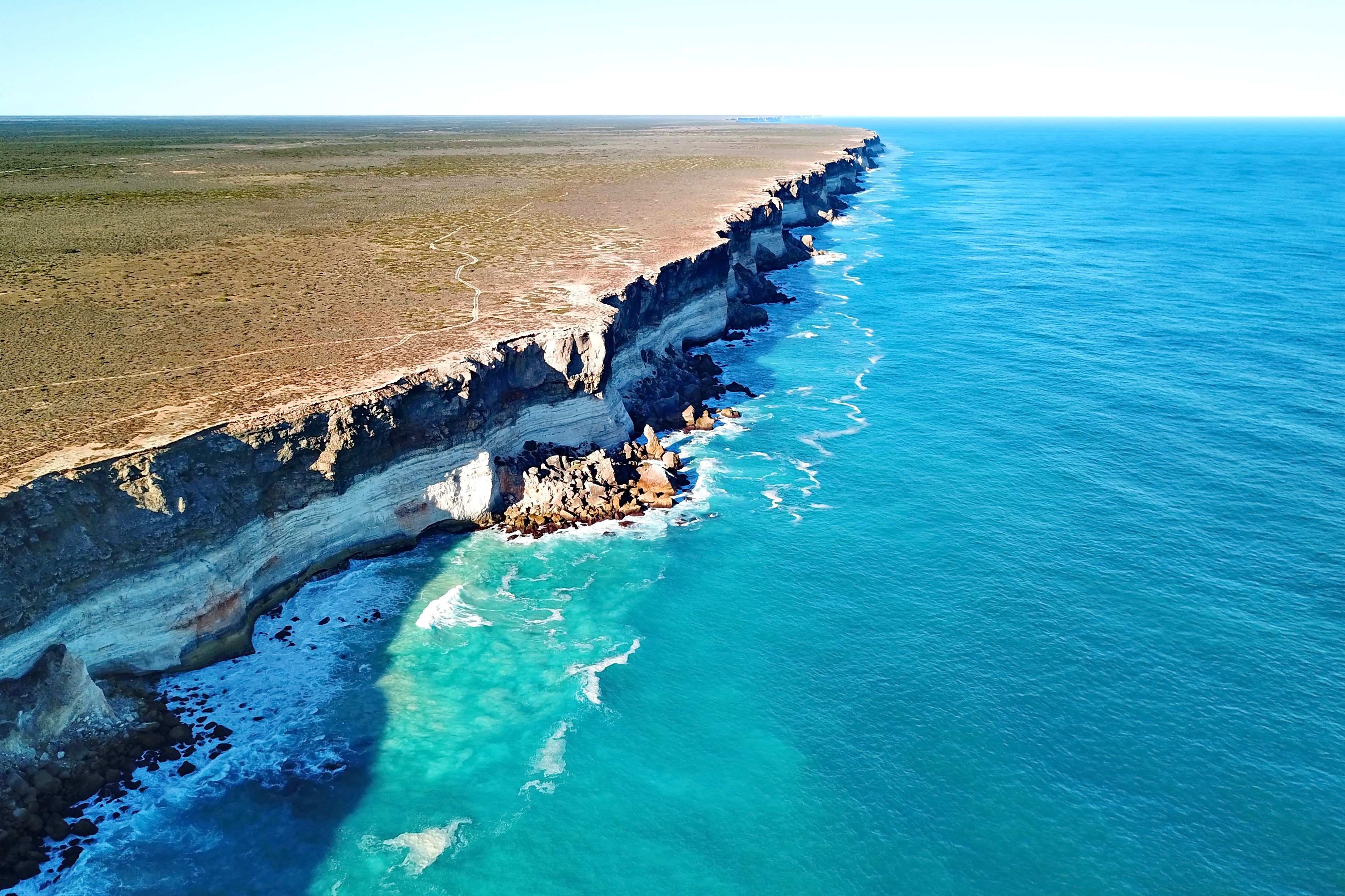 Majestic cliffs of the Great Australian Bight towering over the turquoise waters below. 