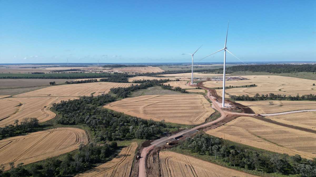 An impressive sight of the Gungahlin Wind Farm, featuring rows of towering wind turbines against the backdrop of rolling hills and open fields, generating clean energy for the community. 