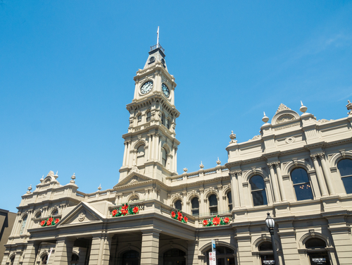 A vibrant image of the Hawthorn Arts Centre, a key cultural landmark in Boroondara. The exterior of the building is featured, showcasing its distinctive architectural style with visitors entering and exiting the building. Inside, art patrons engage with various exhibitions and performances, reflecting the dynamic cultural life of the community. This image conveys the arts centre as a bustling hub of creativity and community engagement.
