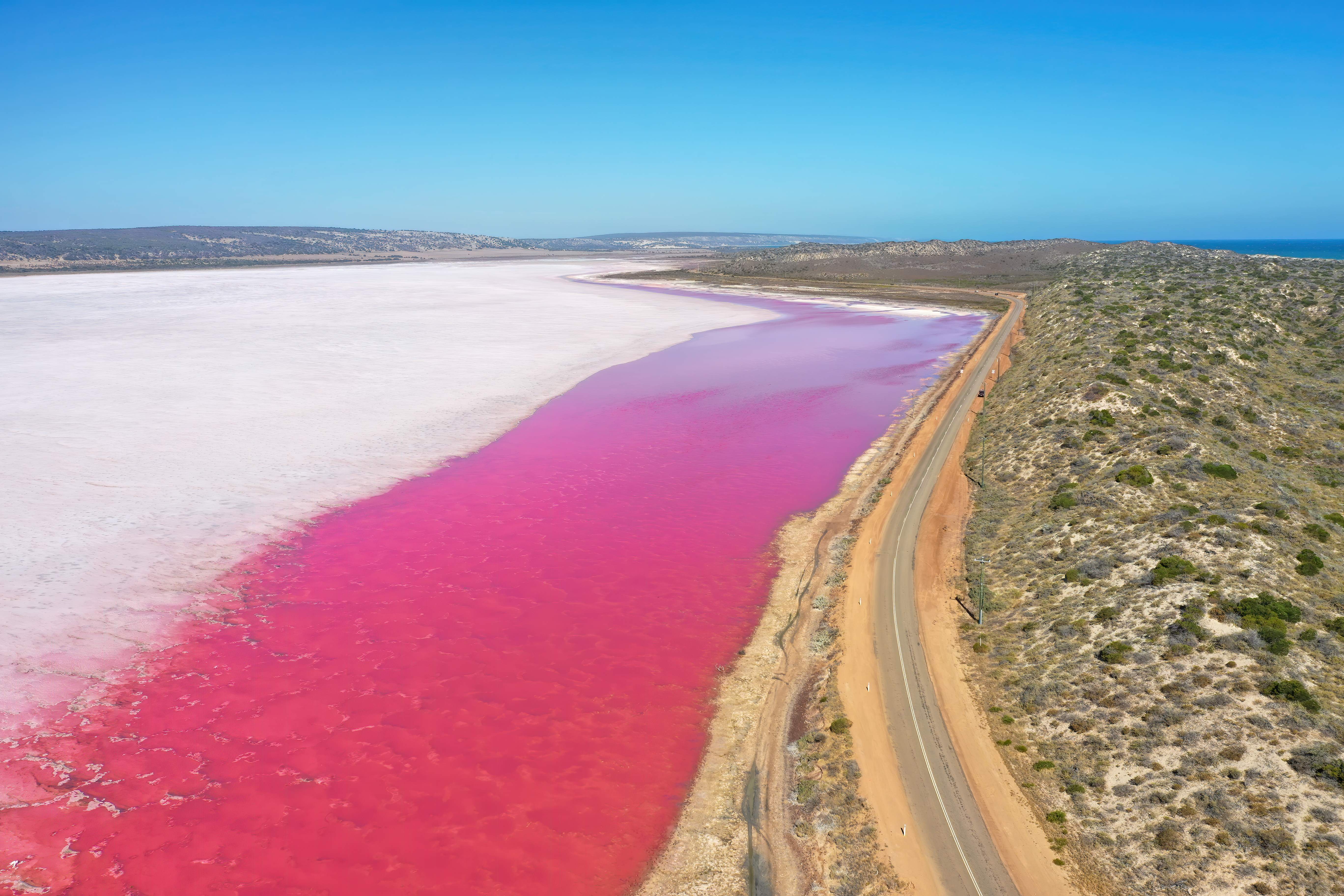 An enchanting scene from Hutt Lagoon, highlighting the pink tones of the lake against the surrounding landscape. 