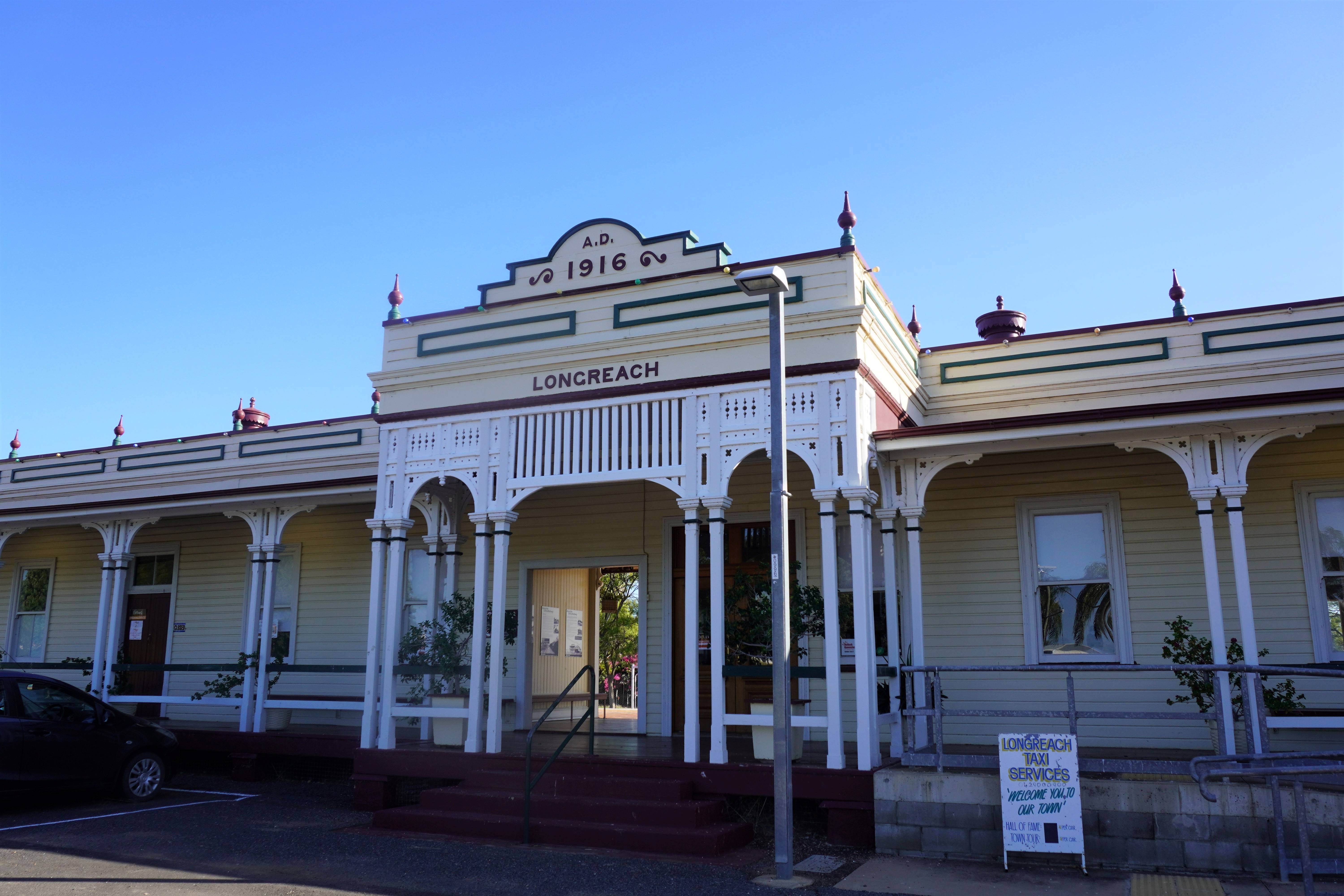 An aerial view of Longreach, showcasing the Thomson River winding through the town and notable landmarks such as the Qantas Founders Museum.