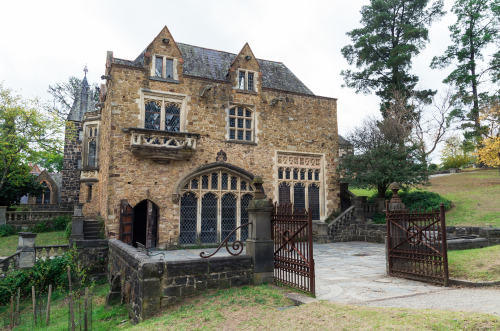Historic Montsalvat artist colony in Nillumbik, Melbourne, showing its rustic and charming architecture surrounded by extensive, well-maintained gardens. The photograph highlights the artistic heritage and picturesque setting of Montsalvat, making it a significant cultural landmark in the region.